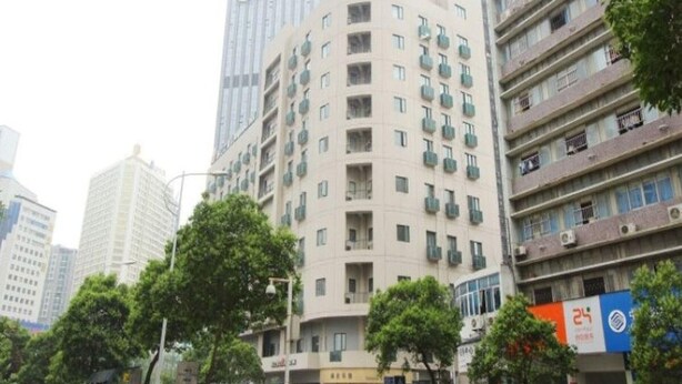 A multi-story building with a central courtyard, surrounded by other high-rise buildings. - Jinjiang Inn Select Hotel (Wuhan)
