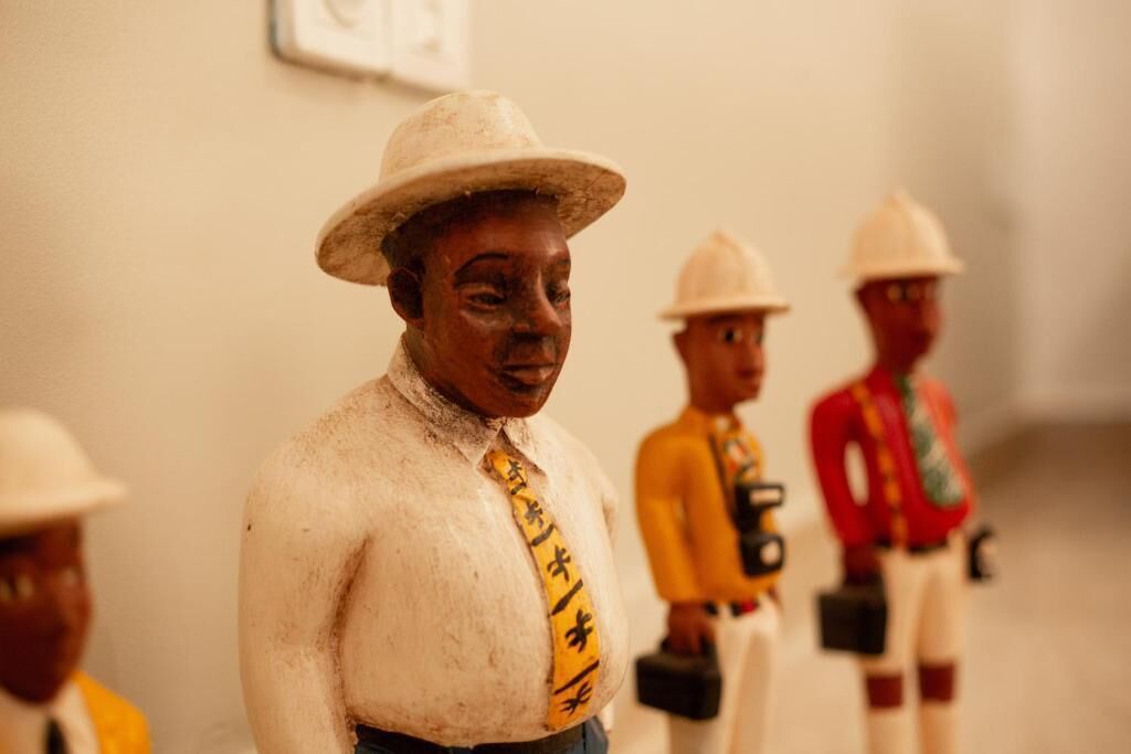 A sculpture of a person wearing a hat and a tie.