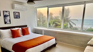 A bedroom with a bed, a large window, and a view of the ocean. - U-go Faro Tequendema (Cartagena)