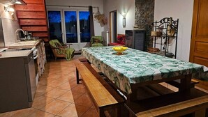 A kitchen with a dining table, a bench, a sink, and a window with a view. - La Ferme - House with terrace (Mélisey)