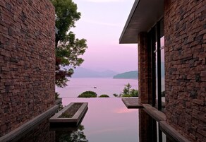 A building with brick walls and a view of a body of water.