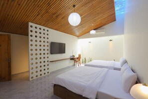 A modern hotel room with a wooden ceiling, a TV mounted on the wall, a desk with a chair, and two beds. - SON HAI HOMESTAY (Thuy Xuan)