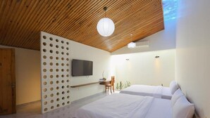 A modern bedroom with a wooden ceiling, two beds, a TV, and a desk with a chair. - SON HAI HOMESTAY (Hue)