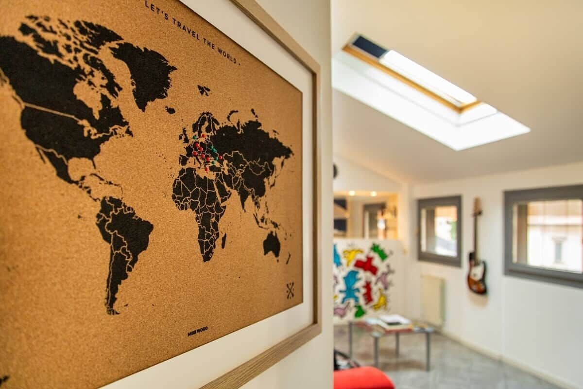 A framed world map with a skylight above.