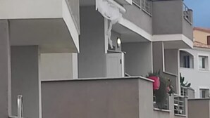 Ein mehrgeschossiges Gebäude mit Balkonen und einem flachen Dach, bewölkter Himmel.