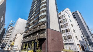 A modern hotel with multiple floors, a prominent entrance, and a clear sky. - ESLEAD HOTEL Namba East (Osaka)