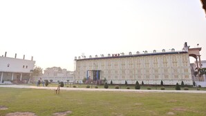 A large building with a symmetrical facade, multiple windows, and a central entrance.
