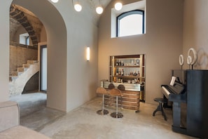 A modern interior with a bar area, a piano, and a staircase. - Luxury villa with pool, Etna view - Fiumè, Di Casa In Sicilia (Fiumefreddo di Sicilia)
