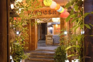 A wooden building entrance with steps leading to a reception area. - Just wait for you- English reception-Ticket reservation (Zhangjiajie)