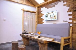 A wooden bench with a cushion, a table with a vase, and a window with curtains. - Just wait for you- English reception-Ticket reservation (Zhangjiajie)
