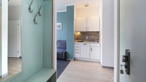 A modern kitchen with white cabinets, a sink, and a countertop. - Appartement Nr. 08 (Rostock)
