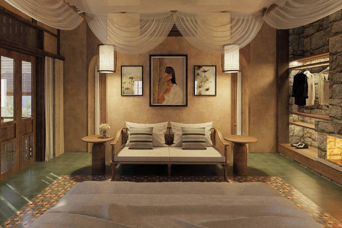 Quarto com uma cama grande, parede de pedra e um cabideiro.