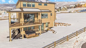 A two-story house with a balcony, a covered porch, and a stone pathway. - Dual-Homes, 10br10ba, Sleeps 32, 2 HotTubs-Views (Heber City)