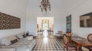 A spacious living area with a sofa set, a dining table, and a patterned floor. - Exclusive beachfront villa, 6 bedrooms, garden, Monopoli (Monopoli)