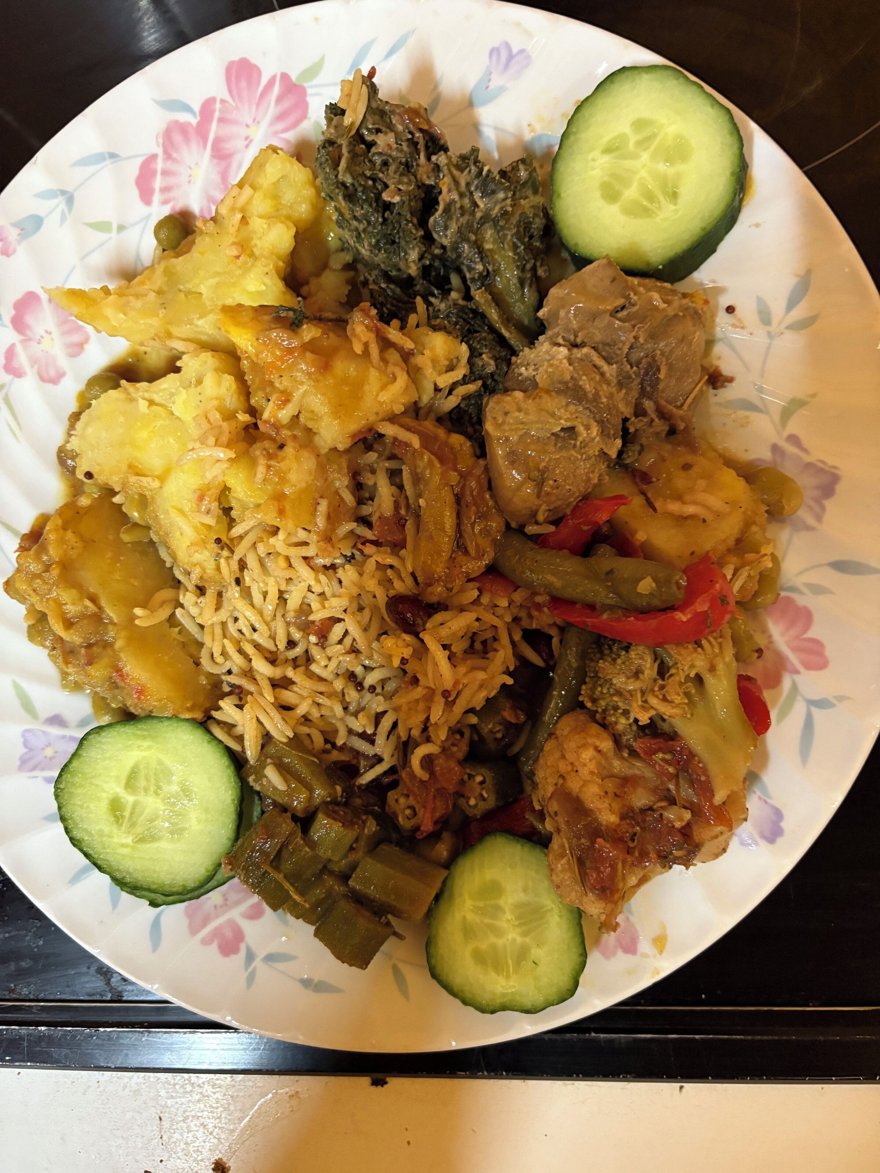 A plate of food with rice, meat, and vegetables.