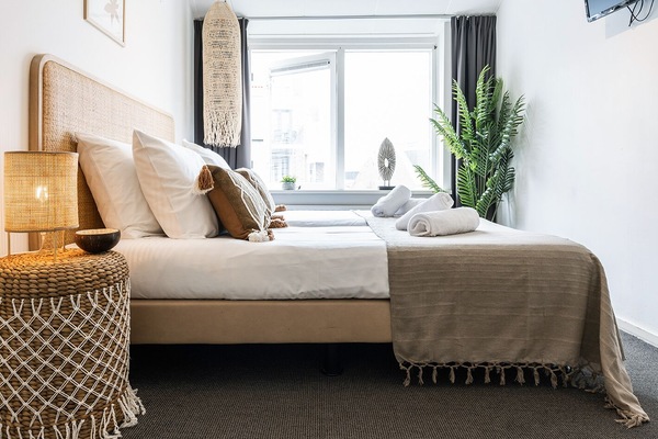 Comfortable bedroom with a soft bed, cozy lighting, and a serene, home-like feel.