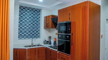 Suíte, 2 quartos | Cozinha privada