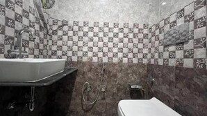A bathroom with a sink, toilet, and shower.