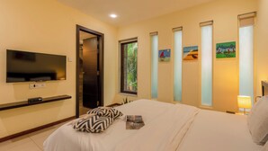 A hotel room with a bed, a TV, a window, and artwork on the wall. - Staymaster Casa Amaira 3BR Villa  (Vagator)