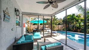 A covered patio with wicker furniture, a pool, and a view of the backyard. - Summer House - Oasis pool house in the heart of Sarasota (Sarasota)