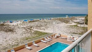 A poolside view with a beach and ocean in the background. - Big Surf 1E 2D - Gulf View Beach Pool and Fun (Gulf Shores)