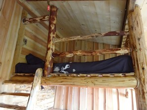 A wooden cabin interior with a bunk bed, a wooden ceiling, and a window. - Guest Room 'Le Ranch' with Mountain View, Shared Garden and Wi-Fi (Lafarre)