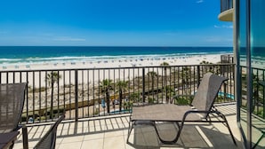 A balcony with a view of a beach and ocean. - Phoenix West 407 3 Bedroom Condo (Orange Beach)