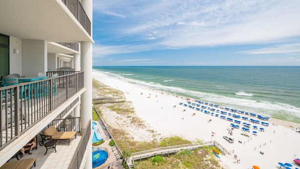 A hotel with a balcony overlooking a beach with umbrellas and lounge chairs. - The Oasis 1104 Formerly Phoenix West Ii 1104 3 Bedroom Condo (Orange Beach)