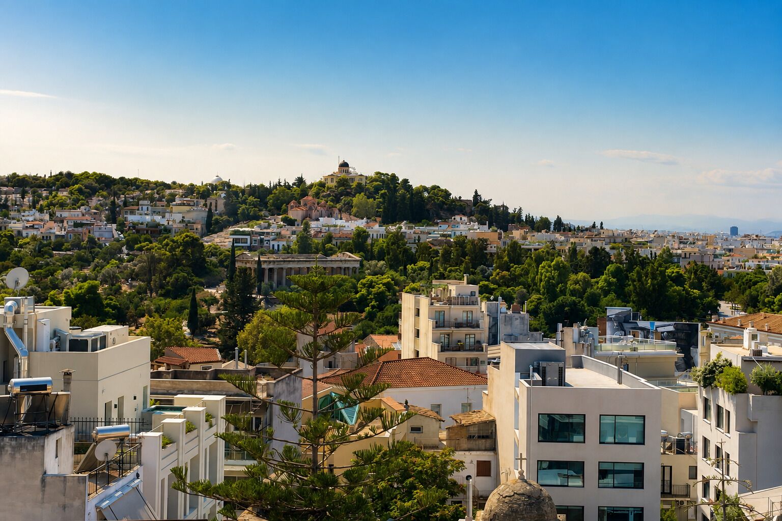 A cityscape with modern buildings, a hilltop with historical structures, and a clear sky.