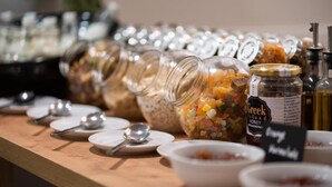 A buffet table with various food items and condiments. - Amaris Hotel & Spa by Athens Prime Hotels (Athens)