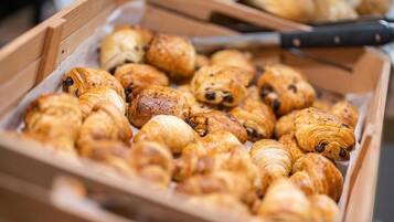 A wooden box filled with assorted pastries.