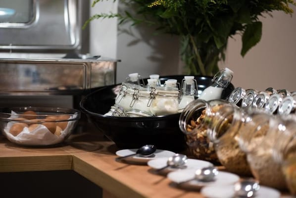 A buffet setup with various food items and containers. - Amaris Hotel & Spa by Athens Prime Hotels (Athens)