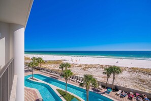 A pool area with a view of a beach and ocean. - The Oasis 302 Formerly Phoenix West Ii 302 3 Bedroom Condo (Orange Beach)