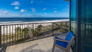 A balcony with a view of a beach and ocean. - Phoenix West 403 3 Bedroom Condo (Orange Beach)