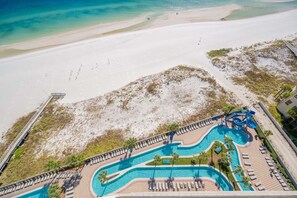 A resort with a large pool, beach access, and a water slide. - The Oasis 1503 Formerly Phoenix West Ii 1503 3 Bedroom Condo (Orange Beach)