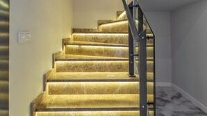 A staircase with marble steps and a metal handrail.