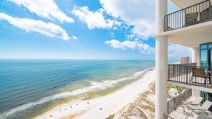 A high-rise hotel with balconies overlooking a beach and ocean. - The Oasis 2204 Formerly Phoenix West Ii 2204 3 Bedroom Condo (Orange Beach)