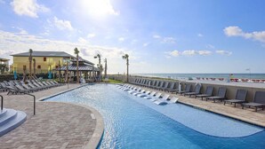 A swimming pool with lounge chairs, a gazebo, and a view of the beach. - The Oasis 2204 Formerly Phoenix West Ii 2204 3 Bedroom Condo (Orange Beach)