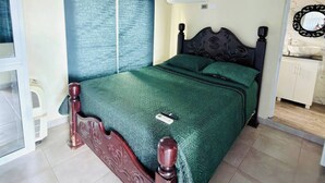 A bedroom with a bed, air conditioning unit, and a mirror. - Charming Villa in Cabrera With Ocean View (Cabrera)