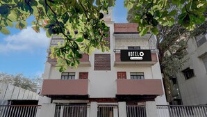 A hotel building with a sign that reads 'HOTEL' and 'Company Service'. - Hotel O Thergoan Formerly P1 Staycation (Pune)