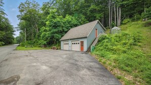 A single-story building with a sloped roof, a garage, and a small porch area.