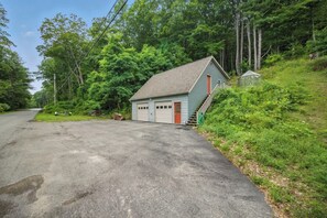 A single-story building with a sloped roof, a garage, and a small porch area.