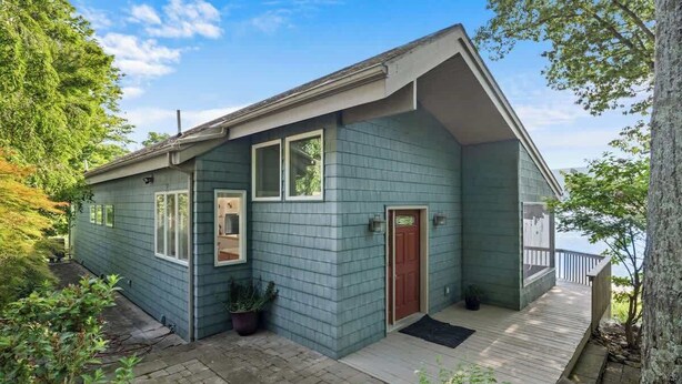 A single-story house with a porch, a door, and a window.