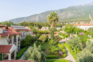 A residential area with houses, a garden, and a mountain in the background. - Gokcen Hotel & Aparments (Fethiye)