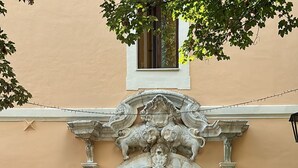 A table set up outside a building with an ornate archway, a sign reading 'Villa Gracassa,' and a candelabra. - VillaGrancassa Historic home from 1853 at the foot of the National Park (San Donato Val di Comino)