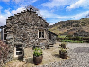 A stone house with a stone staircase, a window, and a gravel driveway. - Beckside Studio (Penrith)