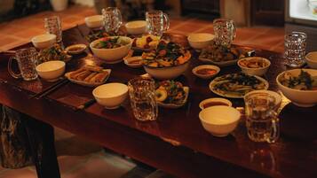 A dining table set with various dishes and beverages, indicating a meal setting.