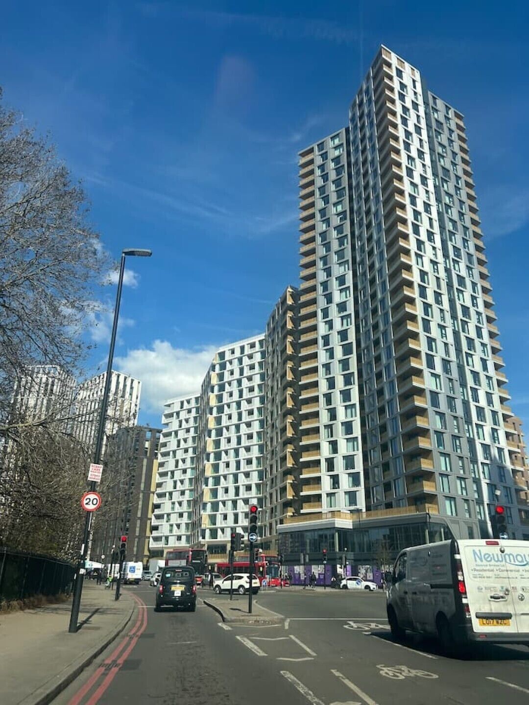 A high-rise building with a modern design, featuring multiple balconies and large windows.