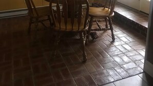 A dining area with a round table, four wooden chairs, a small rug, and a window with blinds. - Perfect for Everyone - 8-bedrooms - The Future Generations University Guesthouse (Franklin)