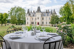 A table set outdoors with a view of a historic building.
